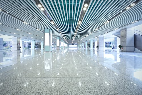 Rows of overhead LED lighting in indoor concourse