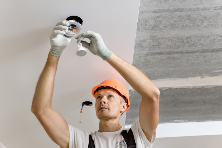 The Electrician Is Installing LED Spotlights On The Ceiling