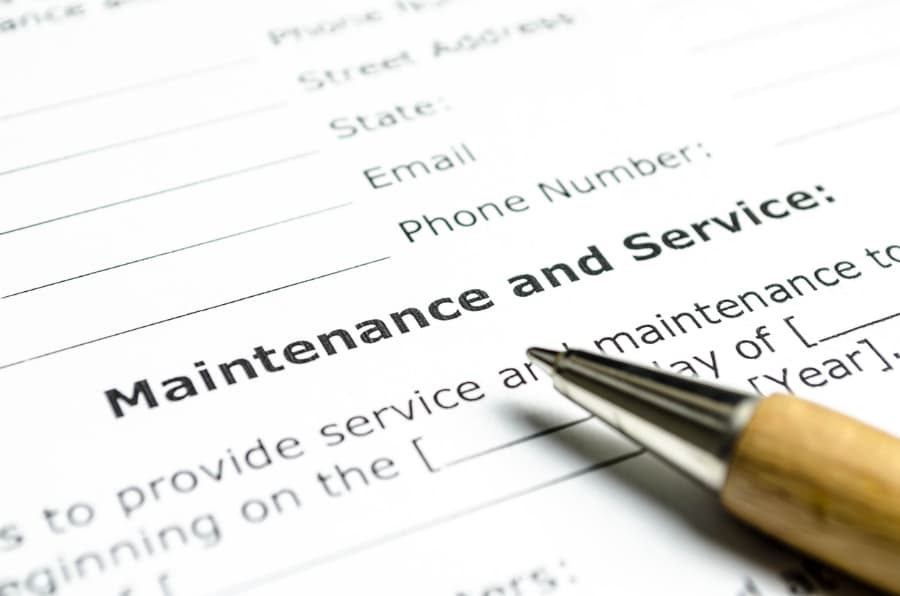 Printed maintenance and service contract with wooden pen on top