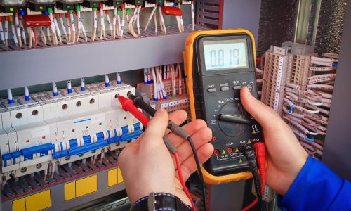 Electrician working with multimeter